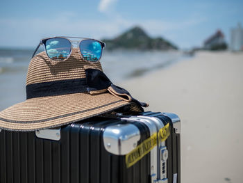 Close-up of sunglasses on beach