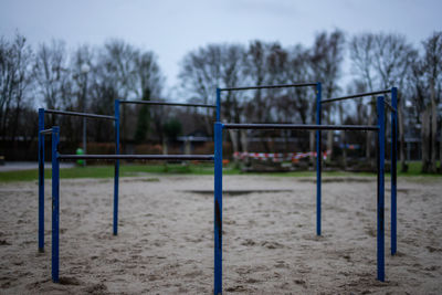 View of empty playground against trees in park
