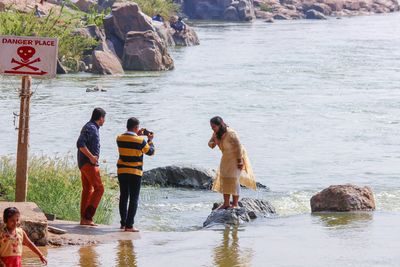 Side view of woman standing in lake