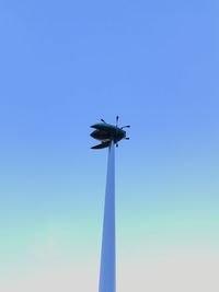 Low angle view of airplane against clear blue sky