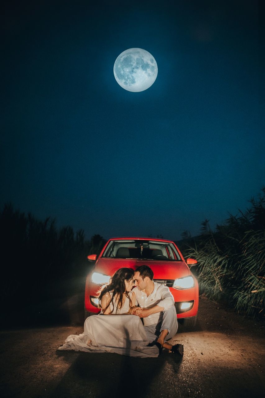 night, moon, sky, full moon, nature, full length, land, people, women, tree, transportation, young adult, field, men, real people, young women, mode of transportation, sitting, illuminated, two people, outdoors, couple - relationship, moonlight