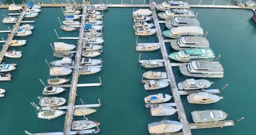 High angle view of sailboats moored at harbor