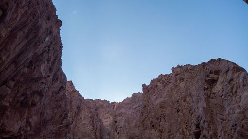 Low angle view of rock formations against sky