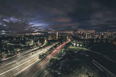 High angle view of city lit up at night