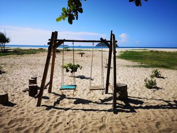 Plants on sandy beach against sky