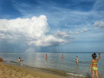 Scenic view of beach against cloudy sky