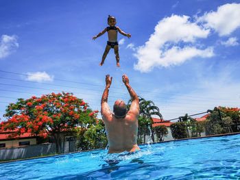 Father and daughter have fun in the pool