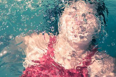 Close-up of a woman swimming underwater