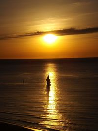 Scenic view of sea against orange sky