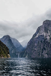 Scenic view of sea and mountains against sky