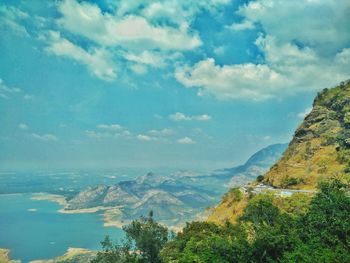 Scenic view of mountains against cloudy sky