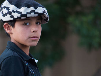 Close-up portrait of boy looking away outdoors