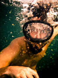 Close-up portrait of man snorkeling in sea