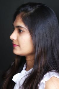 Close-up portrait of a beautiful woman looking away