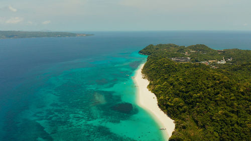 Tropical white sand beach, near the blue lagoon and corall reef from above, boracay, philippines. 