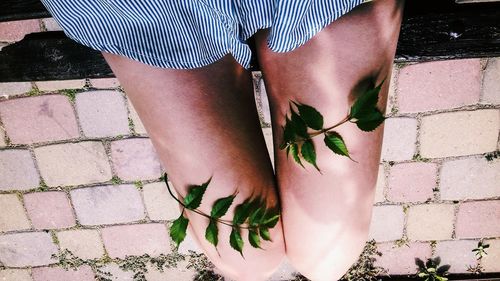 Midsection of man standing against wall