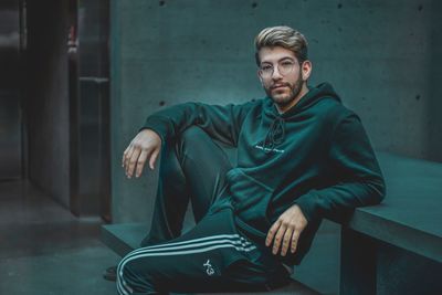 Portrait of young man sitting outdoors