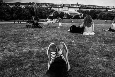 Low section of people relaxing on field