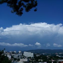 High angle view of buildings against blue sky