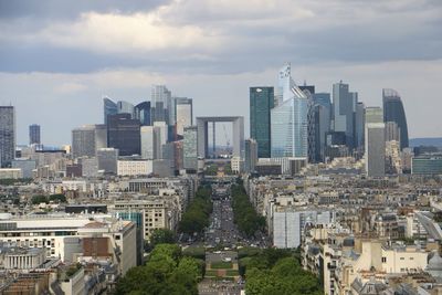 Aerial view of buildings in city against sky