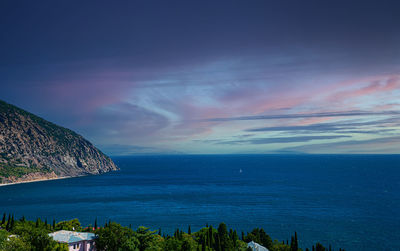 Scenic view of sea against rainbow in sky