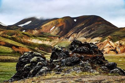 Scenic view of rocks and mountains against sky