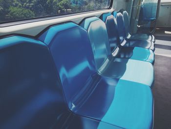 High angle view of blue seats in train