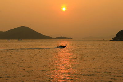 Scenic view of sea against orange sky