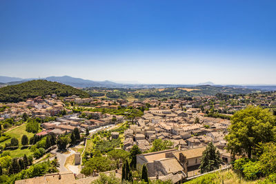 Aerial view of townscape against clear blue sky
