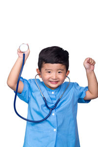 Portrait of smiling boy standing against white background