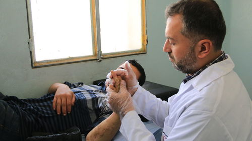 Doctor examining patient in clinic