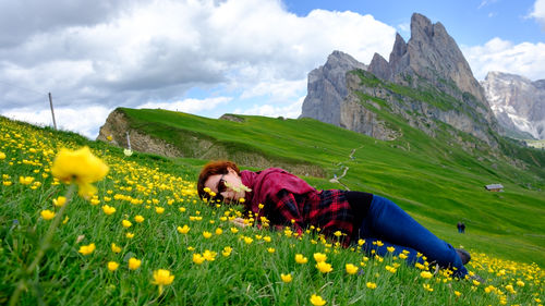 Portrait of woman lying on flowering plants