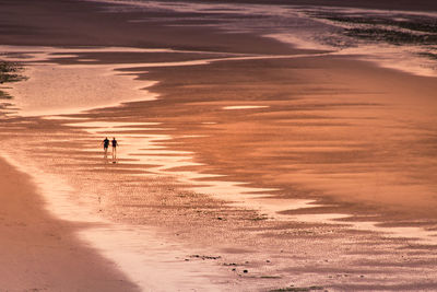 Scenic view of beach against sky during sunset