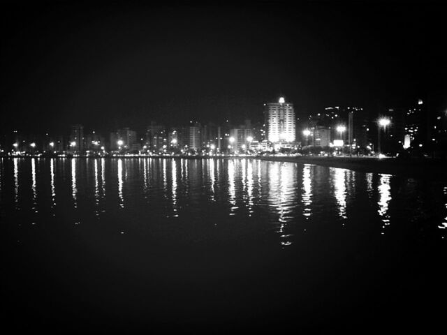 night, illuminated, water, reflection, waterfront, building exterior, city, architecture, built structure, clear sky, river, sea, copy space, dark, cityscape, no people, lighting equipment, outdoors, sky, skyscraper