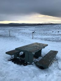 Scenic view of frozen lake against sky during sunset