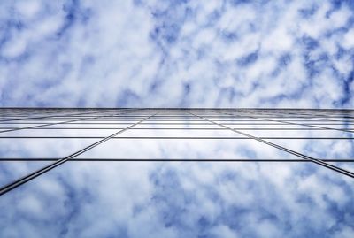 Low angle view of cables against cloudy sky