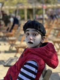 Portrait of young boy with pantomime outfit outdoors