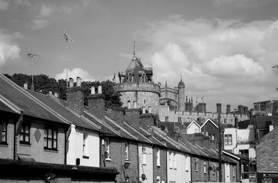 Buildings in town against sky