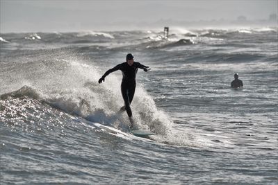 People on sea against sky