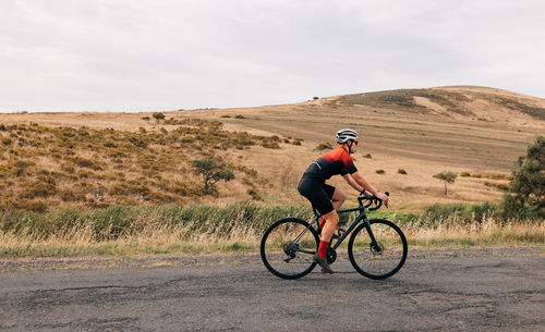 Man riding bicycle on field