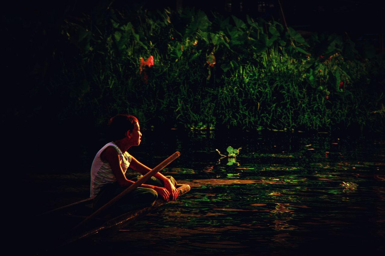 SIDE VIEW OF A YOUNG MAN IN LAKE