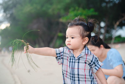 Full length of cute girl holding hands