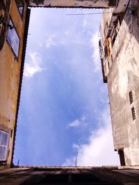 Low angle view of building against cloudy sky