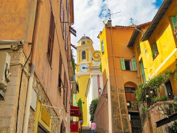 Low angle view of buildings in town against sky