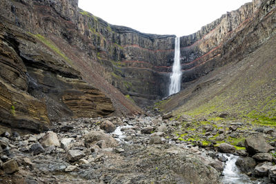 Scenic view of waterfall against rocks