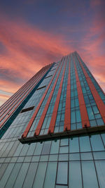 Low angle view of modern building against sky during sunset