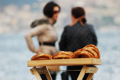 Baked food on table with women in background