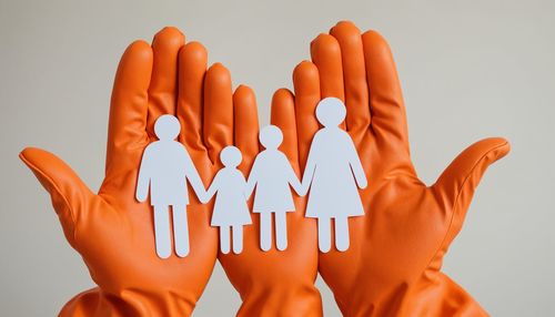 Cropped hand of woman gesturing against white background