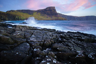 Scenic view of waterfall against sky