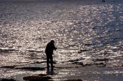 Silhouette man walking on beach